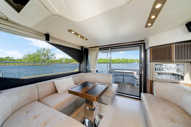 Our Trade Yacht Photos Pics Luxurious interior of 2018 Azimut 50 Fly yacht with elegant seating and scenic water view.