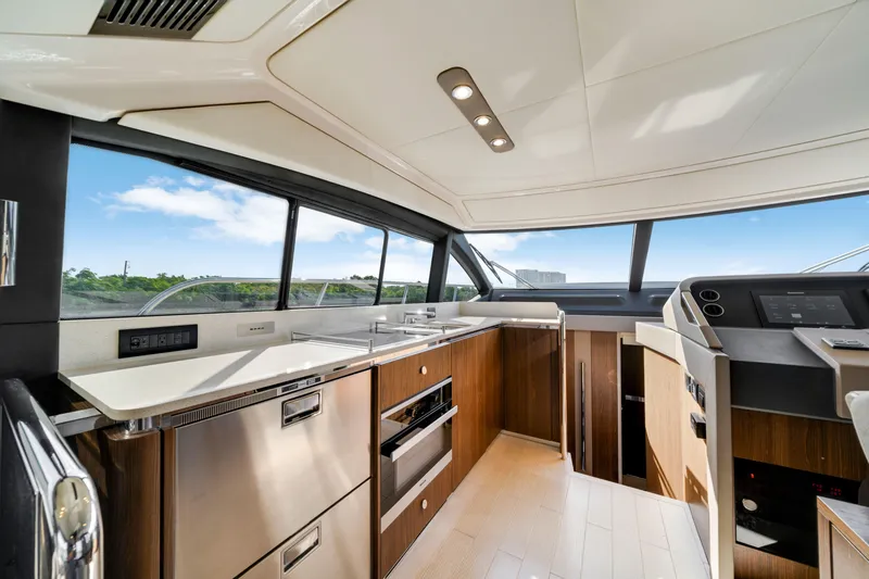 Our Trade Yacht Photos Pics Luxurious interior of 2018 Azimut 50 Fly yacht with modern kitchen and panoramic windows.