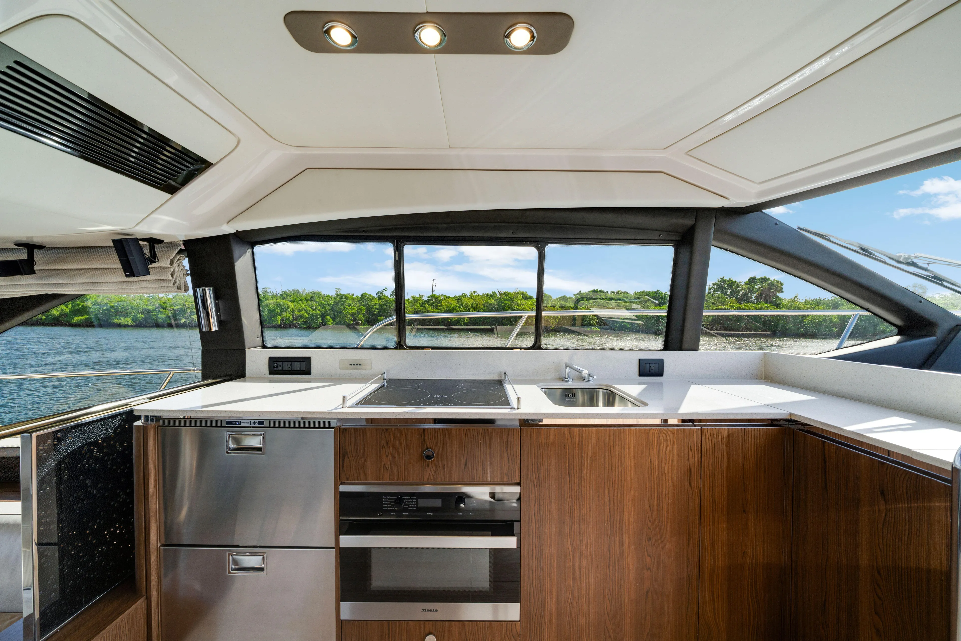 Our Trade Yacht Photos Pics Luxurious kitchen interior of 2018 Azimut 50 Fly yacht with modern appliances and scenic view.