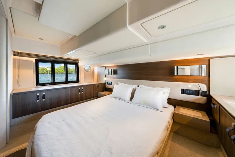 Our Trade Yacht Photos Pics Luxurious bedroom interior of 2018 Azimut 50 Fly yacht with modern design and scenic window view.