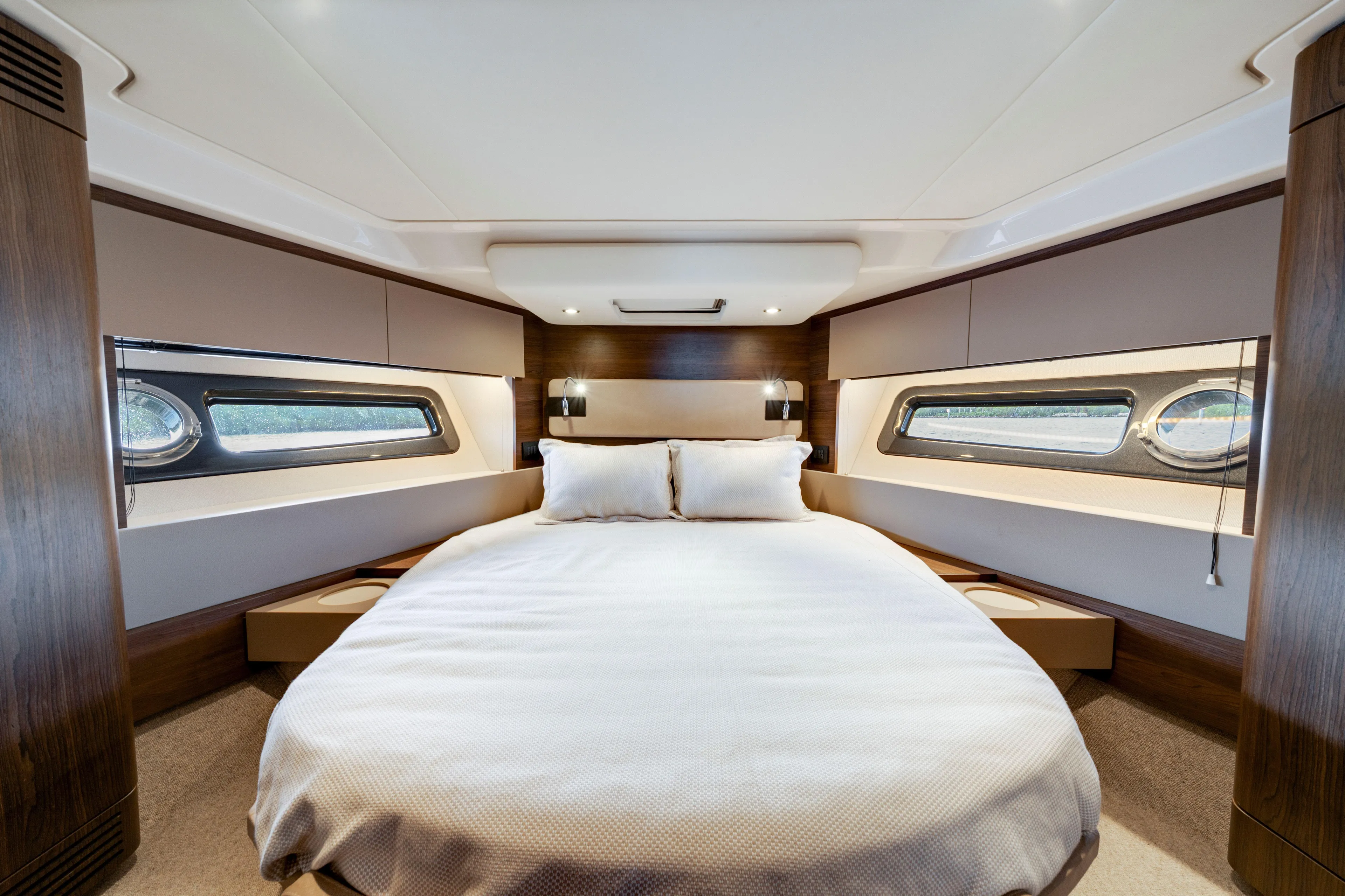 Our Trade Yacht Photos Pics Luxurious bedroom interior of 2018 Azimut 50 Fly yacht with elegant design and porthole windows.