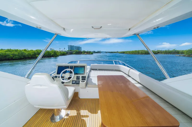 Our Trade Yacht Photos Pics Flybridge view of 2018 Azimut 50 Fly yacht, featuring helm and seating area.