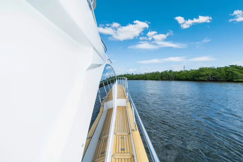 Our Trade Yacht Photos Pics Azimut 50 Fly 2018 yacht cruising on a serene river under a clear blue sky.