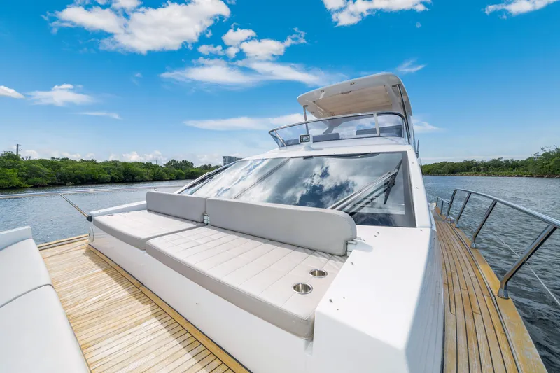 Our Trade Yacht Photos Pics 2018 Azimut 50 Fly yacht on a serene river, featuring sleek design and spacious deck.