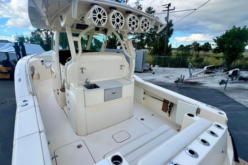  Yacht Photos Pics 2023 Scout 330 LXF boat interior with seating, speakers, and storage compartments.