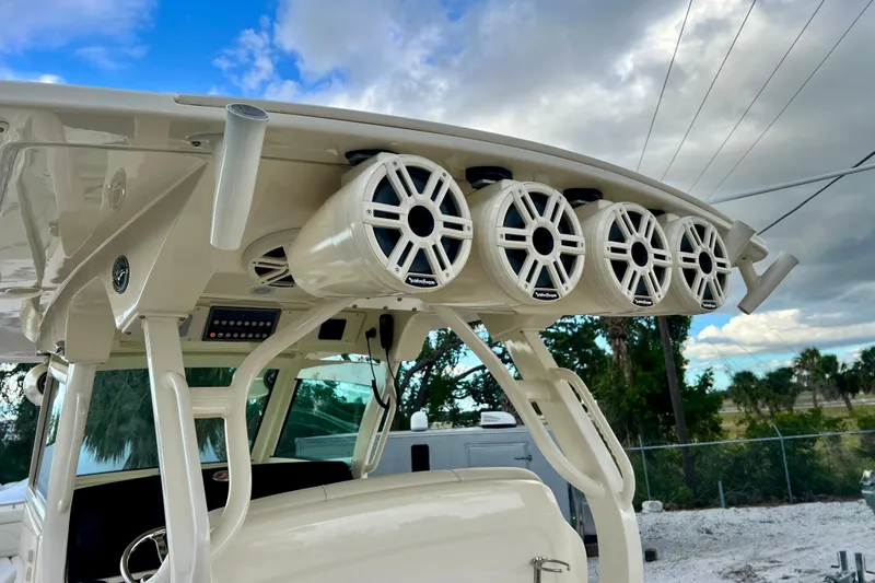  Yacht Photos Pics 2023 Scout 330 LXF boat with mounted speakers under a cloudy sky.