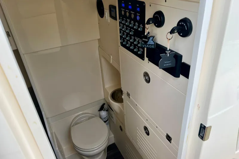  Yacht Photos Pics 2023 Scout 330 LXF boat interior with control panel and toilet.