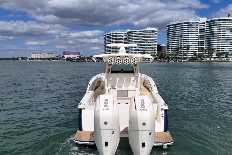  Yacht Photos Pics 2023 Scout 330 LXF boat on water with city skyline in background.