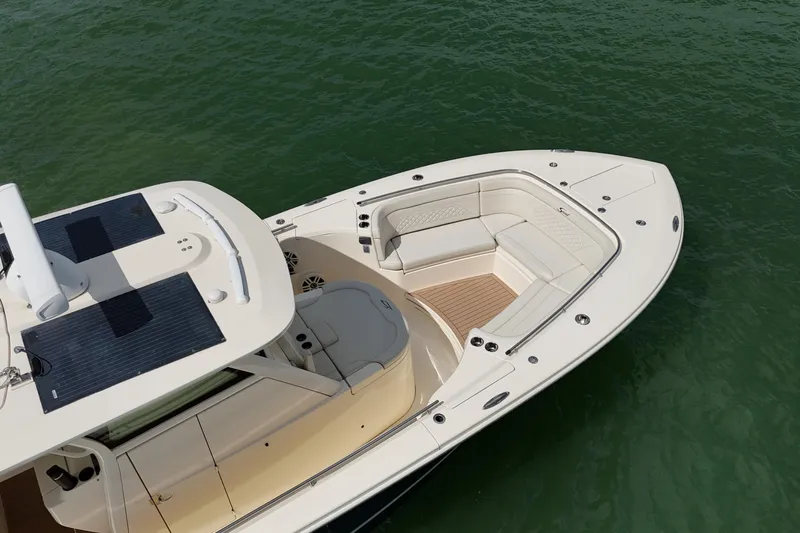  Yacht Photos Pics 2023 Scout 330 LXF boat with spacious seating on calm water.