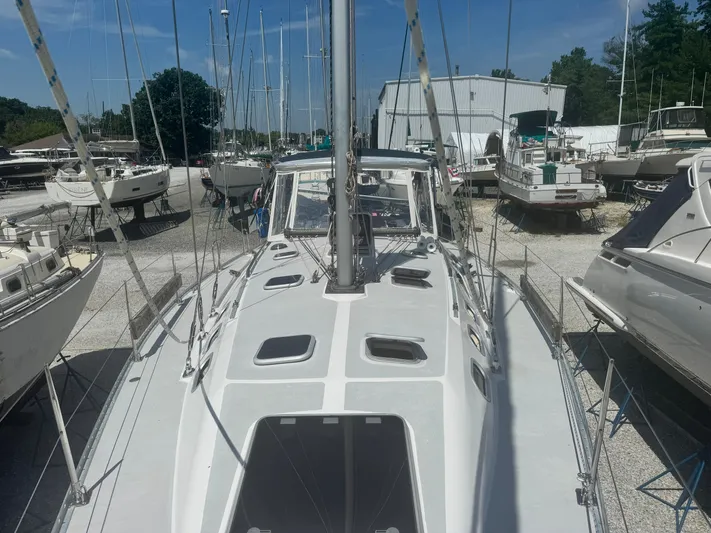 Shenanigans Yacht Photos Pics Catalina 400 MkII sailboat from 2001 in a boatyard, surrounded by other vessels.