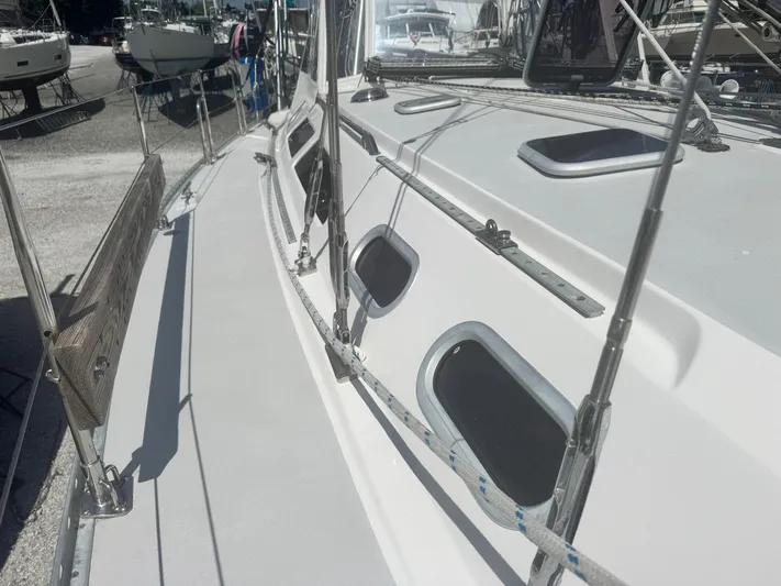 Shenanigans Yacht Photos Pics Side deck view of a 2001 Catalina 400 MkII sailboat in a marina.