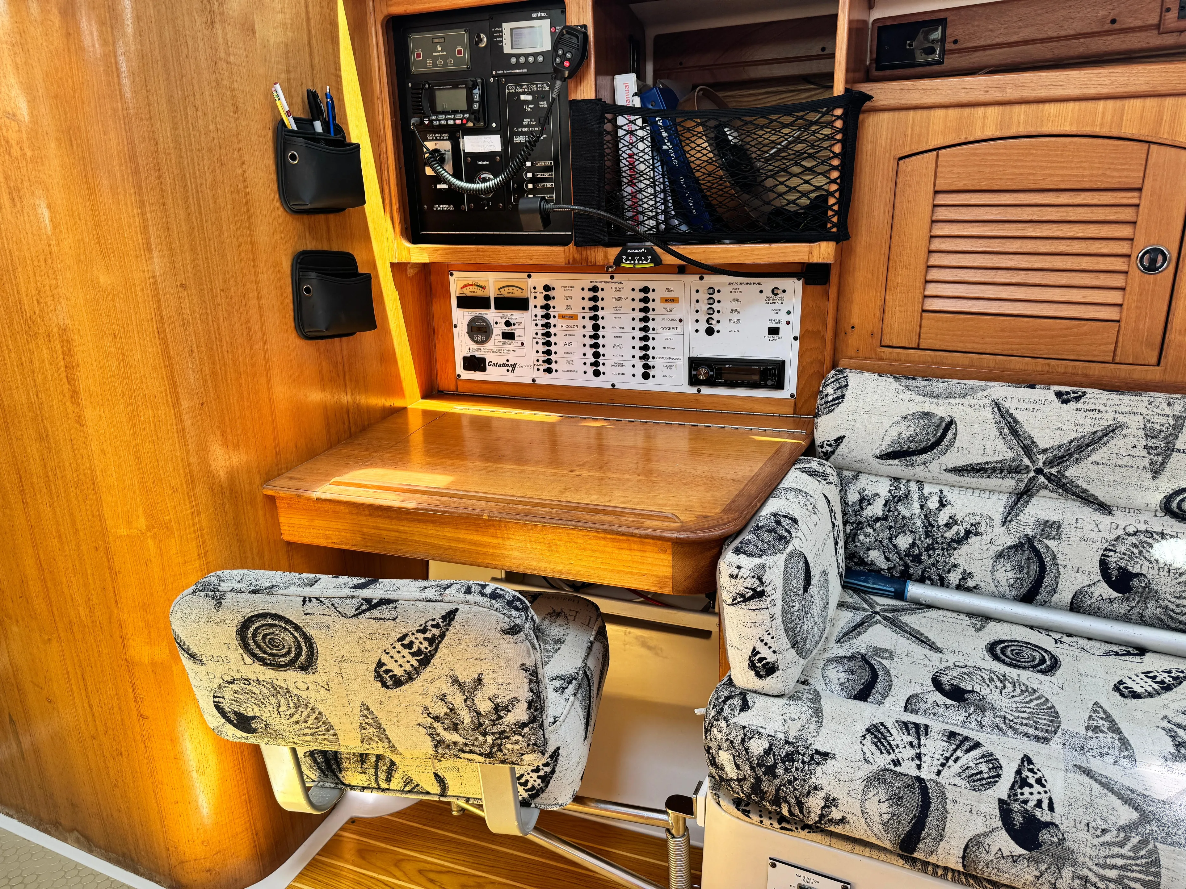 Shenanigans Yacht Photos Pics Interior of 2001 Catalina 400 MkII sailboat with navigation station and patterned seating.
