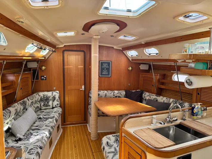 Shenanigans Yacht Photos Pics Interior of a 2001 Catalina 400 MkII sailboat with cozy seating and wooden finishes.