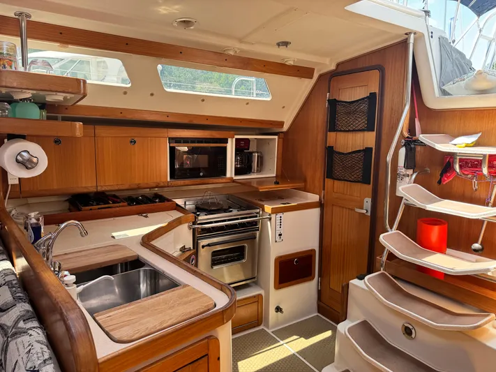 Shenanigans Yacht Photos Pics 2001 Catalina 400 MkII yacht interior with modern kitchen and wooden cabinetry.