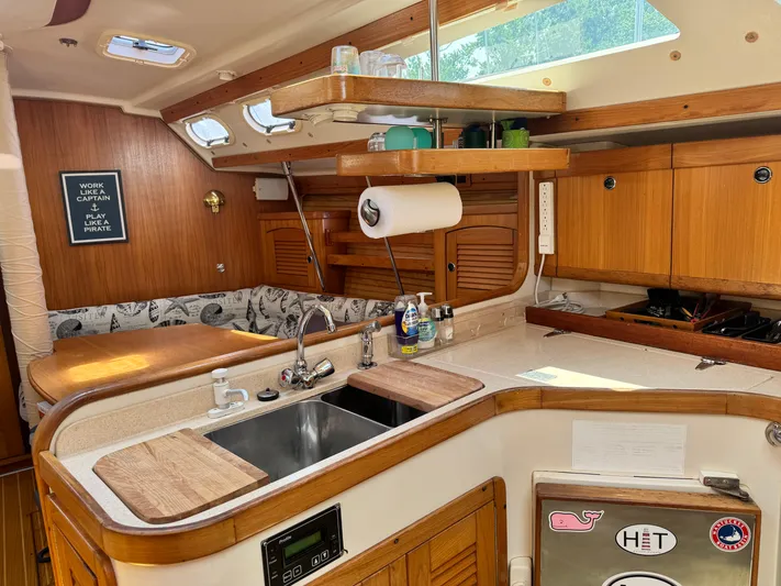 Shenanigans Yacht Photos Pics Interior of 2001 Catalina 400 MkII sailboat kitchen with wood cabinetry and sink.