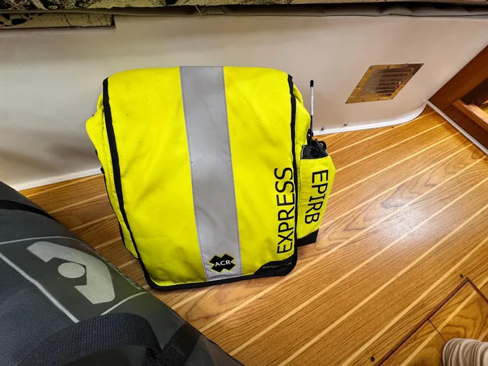 Shenanigans Yacht Photos Pics Yellow EPIRB bag on Catalina 400 MkII 2001 boat with wooden floor.