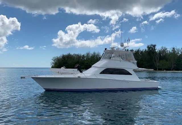 Ayayaiii Yacht Photos Pics 2003 Viking 52 Convertible yacht on calm water with a scenic backdrop.