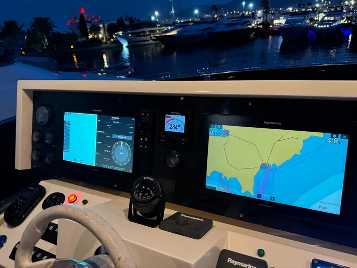 My Biscane Yacht Photos Pics Helm of 2007 Astondoa A 76 GLX yacht with navigation screens at night.