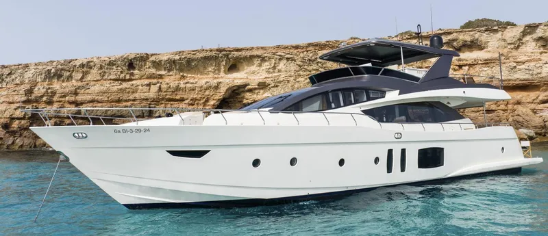 My Biscane Yacht Photos Pics 2007 Astondoa A 76 GLX yacht cruising near rocky coastline in clear blue water.