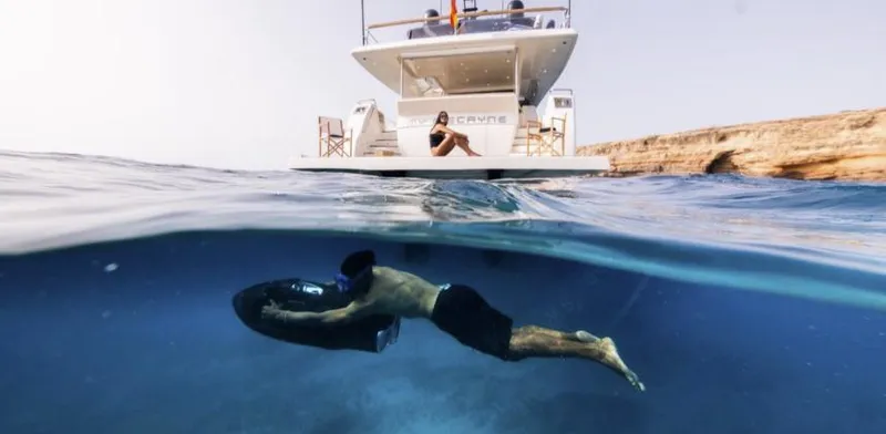 My Biscane Yacht Photos Pics Man snorkeling near 2007 Astondoa A 76 GLX yacht in clear blue water.