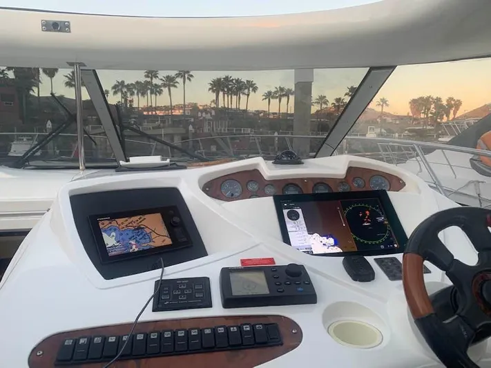 Hot Stuff Yacht Photos Pics Cockpit view of 2000 Sunseeker Predator 56 yacht with navigation screens and controls.