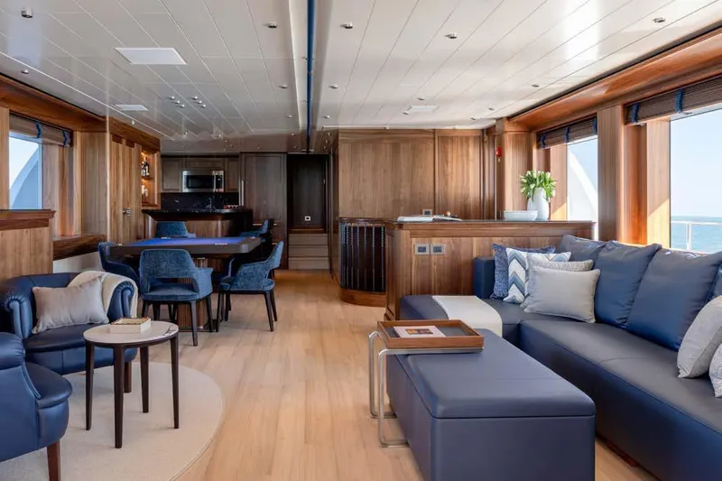 Empire Yacht Photos Pics Luxurious interior of 2024 Cantiere Delle Marche Darwin 86 yacht with elegant wood and blue accents.
