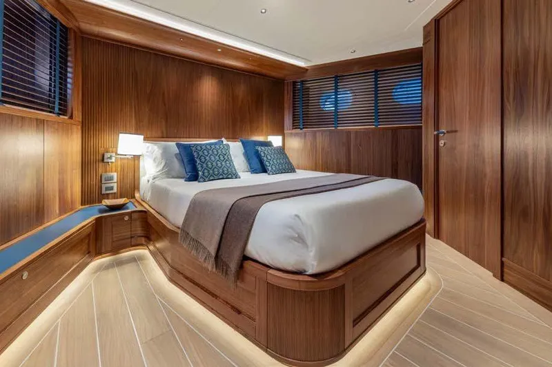 Empire Yacht Photos Pics Luxurious 2024 Cantiere Delle Marche Darwin 86 yacht bedroom with elegant wood paneling.