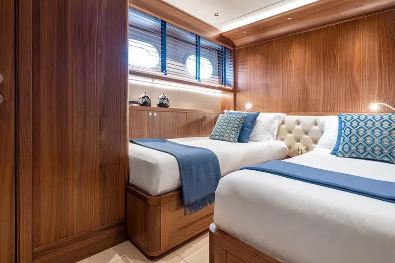 Empire Yacht Photos Pics Luxurious twin cabin on 2024 Cantiere Delle Marche Darwin 86 yacht, featuring elegant wood paneling.