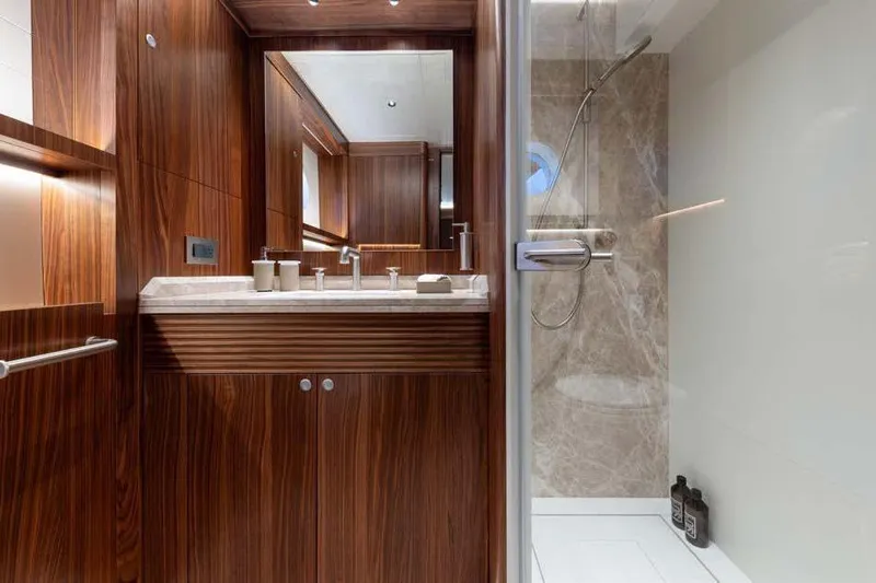 Empire Yacht Photos Pics Luxurious 2024 Cantiere Delle Marche Darwin 86 yacht bathroom with wood accents and modern shower.