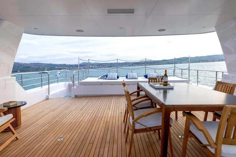 Empire Yacht Photos Pics Luxurious 2024 Cantiere Delle Marche Darwin 86 yacht deck with dining area and sea view.