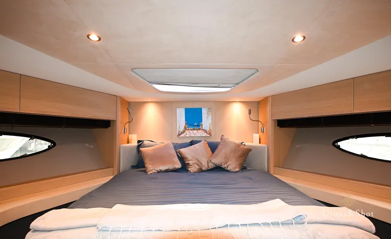  Yacht Photos Pics Luxurious cabin interior of a 2016 Princess yacht with cozy bedding and ambient lighting.