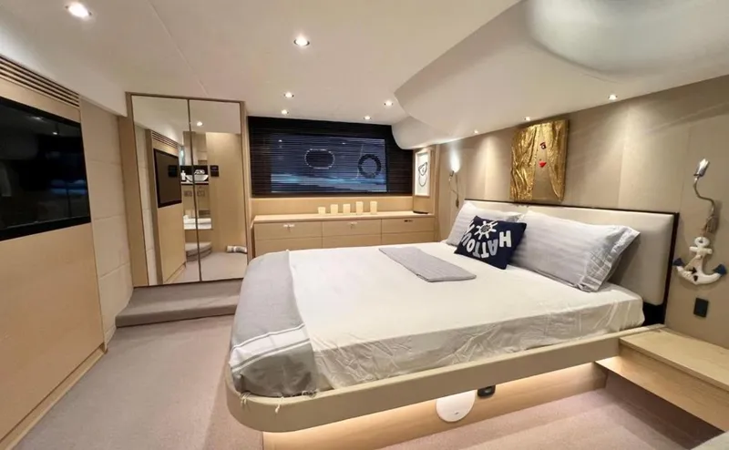  Yacht Photos Pics Luxurious bedroom interior on a 2016 Princess yacht, featuring modern decor and ambient lighting.