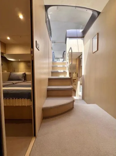 Yacht Photos Pics Interior of a 2016 Princess yacht featuring a modern staircase and cozy bedroom.
