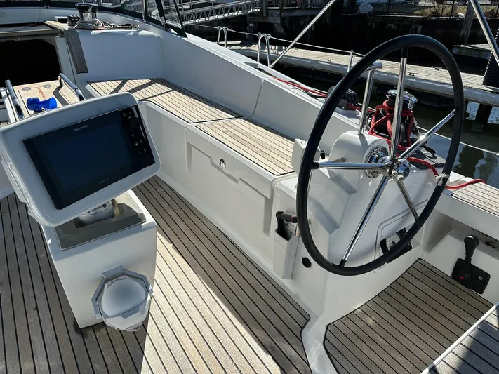 Life Line Yacht Photos Pics Cockpit of 2017 Jeanneau Sun Odyssey 44 DS with steering wheel and navigation display.