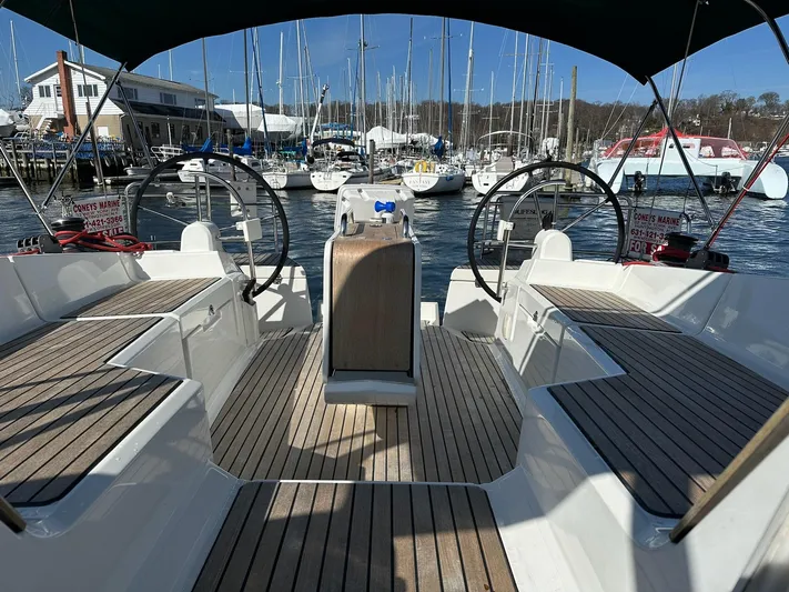 Life Line Yacht Photos Pics 2017 Jeanneau Sun Odyssey 44 DS sailboat cockpit with dual steering wheels, docked at marina.