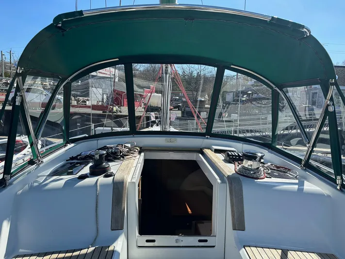 Life Line Yacht Photos Pics 2017 Jeanneau Sun Odyssey 44 DS cockpit with green canopy, docked at marina.
