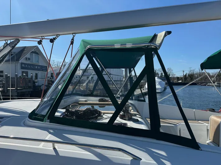 Life Line Yacht Photos Pics Jeanneau Sun Odyssey 44 DS 2017 sailboat with green canopy, docked at marina.