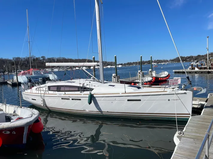 Life Line Yacht Photos Pics 2017 Jeanneau Sun Odyssey 44 DS sailboat docked in a marina under clear blue skies.
