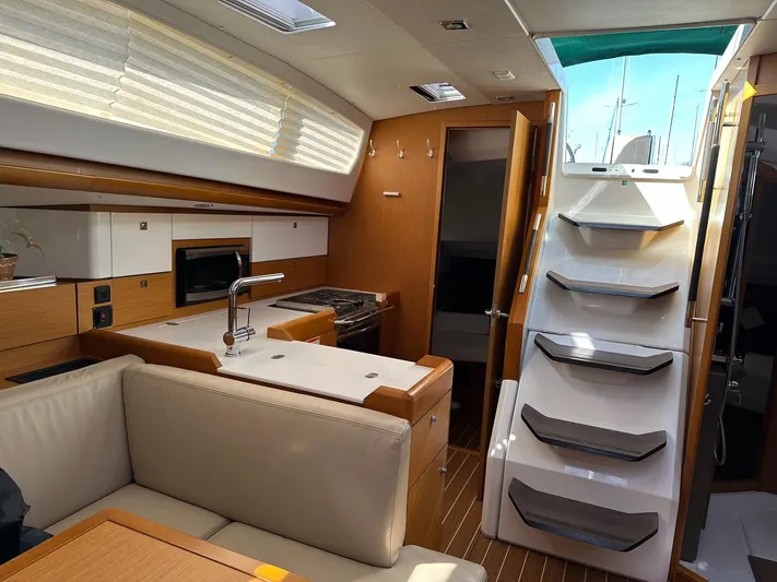 Life Line Yacht Photos Pics Interior of 2017 Jeanneau Sun Odyssey 44 DS yacht, featuring modern kitchen and seating area.