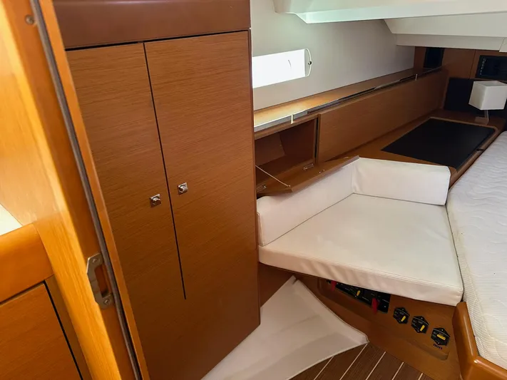 Life Line Yacht Photos Pics Interior of 2017 Jeanneau Sun Odyssey 44 DS yacht, featuring wooden cabinetry and cozy seating.