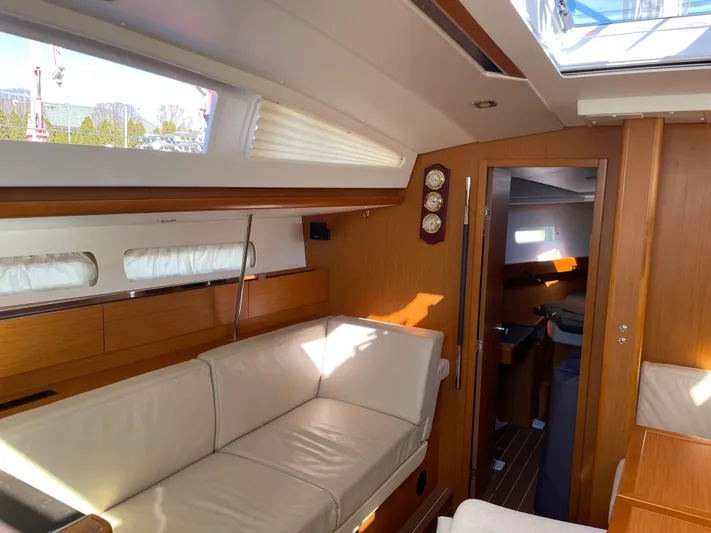 Life Line Yacht Photos Pics Interior of 2017 Jeanneau Sun Odyssey 44 DS yacht with elegant wood finish and comfortable seating.