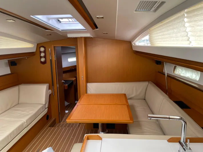 Life Line Yacht Photos Pics Interior of 2017 Jeanneau Sun Odyssey 44 DS yacht with elegant wood finish and seating area.