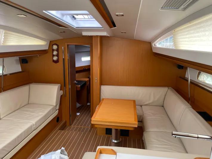Life Line Yacht Photos Pics Interior of 2017 Jeanneau Sun Odyssey 44 DS yacht with elegant wood finish and comfortable seating.