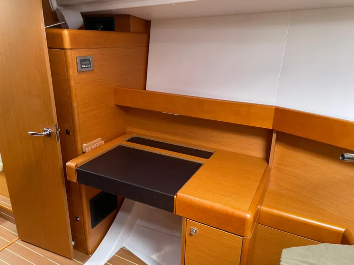Life Line Yacht Photos Pics Interior of 2017 Jeanneau Sun Odyssey 44 DS yacht with wooden cabinetry and desk.