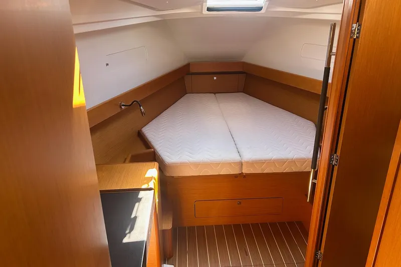Life Line Yacht Photos Pics Interior cabin of 2017 Jeanneau Sun Odyssey 44 DS yacht with wooden finish and bed.