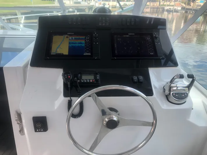 Re-fit 2021-2024 With 2017 Cummins 540s Yacht Photos Pics 1995 Cabo 35 Express helm with navigation screens and steering wheel.