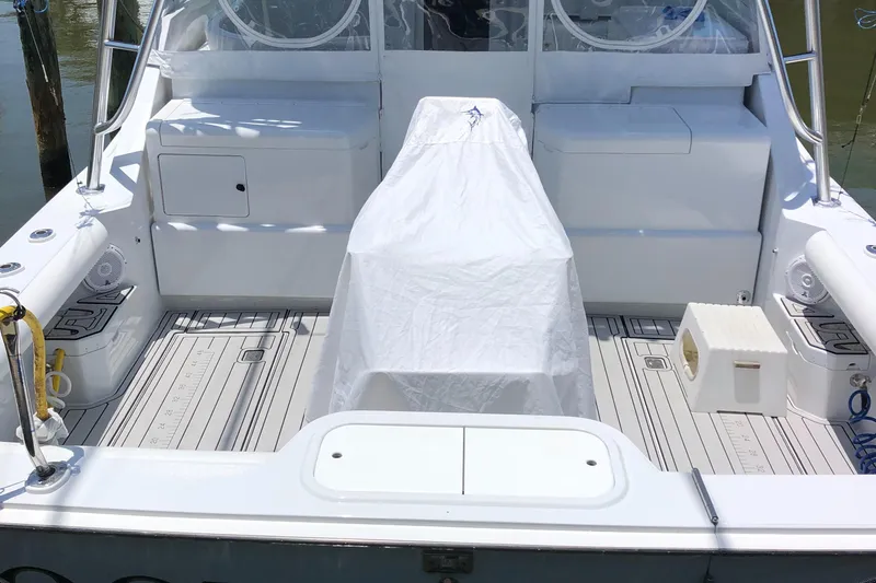 Re-fit 2021-2024 With 2017 Cummins 540s Yacht Photos Pics 1995 Cabo 35 Express boat deck with covered seating and storage compartments.