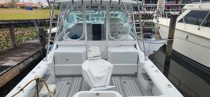 Re-fit 2021-2024 With 2017 Cummins 540s Yacht Photos Pics 1995 Cabo 35 Express boat docked, featuring spacious deck and covered seating area.