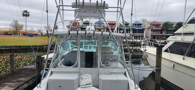 Re-fit 2021-2024 With 2017 Cummins 540s Yacht Photos Pics 1995 Cabo 35 Express boat docked at marina with colorful buildings in background.