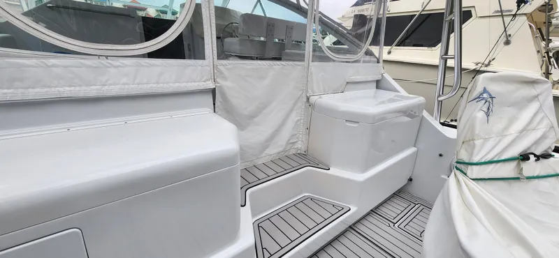 Re-fit 2021-2024 With 2017 Cummins 540s Yacht Photos Pics 1995 Cabo 35 Express boat interior with seating and covered deck area.